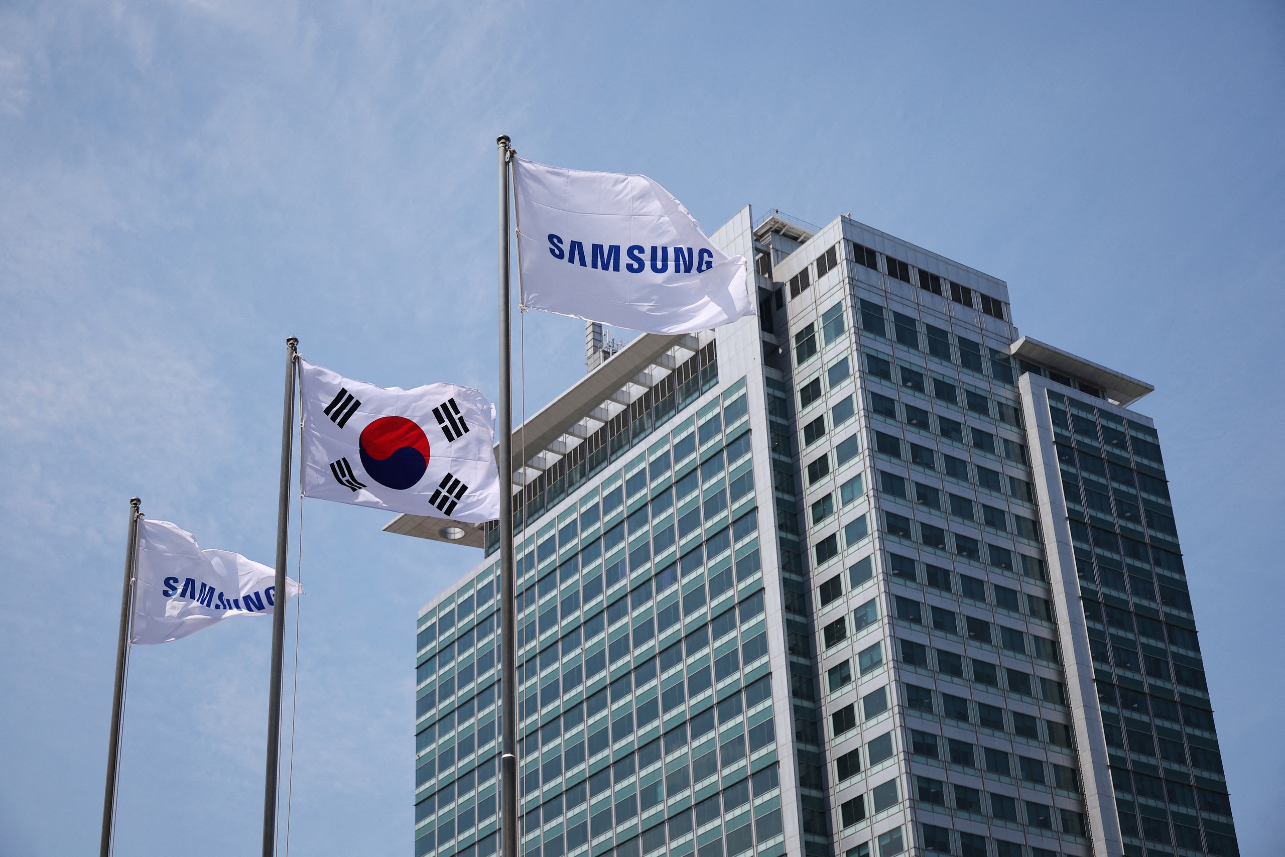 Flags with the logo of Samsung Electronics are seen during a media tour at Samsung Electronics' headquarters in Suwon, South Korea, June 13, 2023. REUTERS/Kim Hong-Ji/File Photo