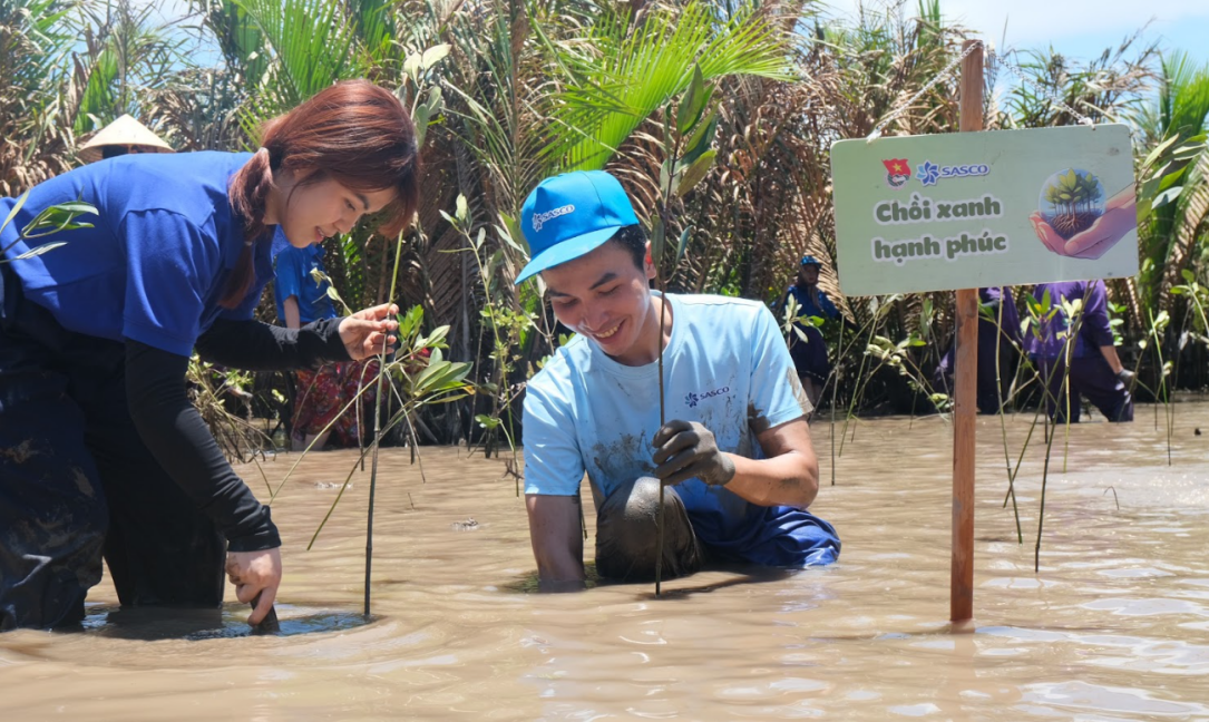A group of people in a muddy area Description automatically generated