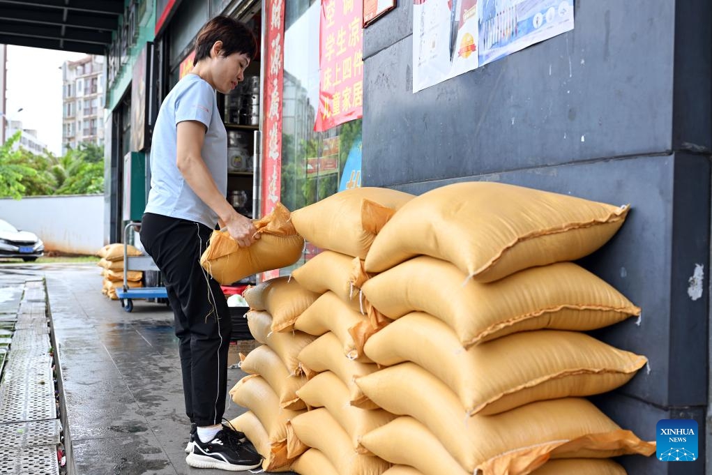 An employee arranges a sandbag barrier ahead of the landfall of typhoon Yagi in Haikou, south China's Hainan Province, Sept. 5, 2024. The State Flood Control and Drought Relief Headquarters raised its emergency response for flood and typhoon prevention from level III to level II in Guangdong and Hainan provinces at 3 p.m. Thursday, as typhoon Yagi approaches. Yagi is expected to make landfall on Friday afternoon or evening somewhere between the city of Qionghai in Hainan and Maoming City in Guangdong. (Xinhua/Guo Cheng)