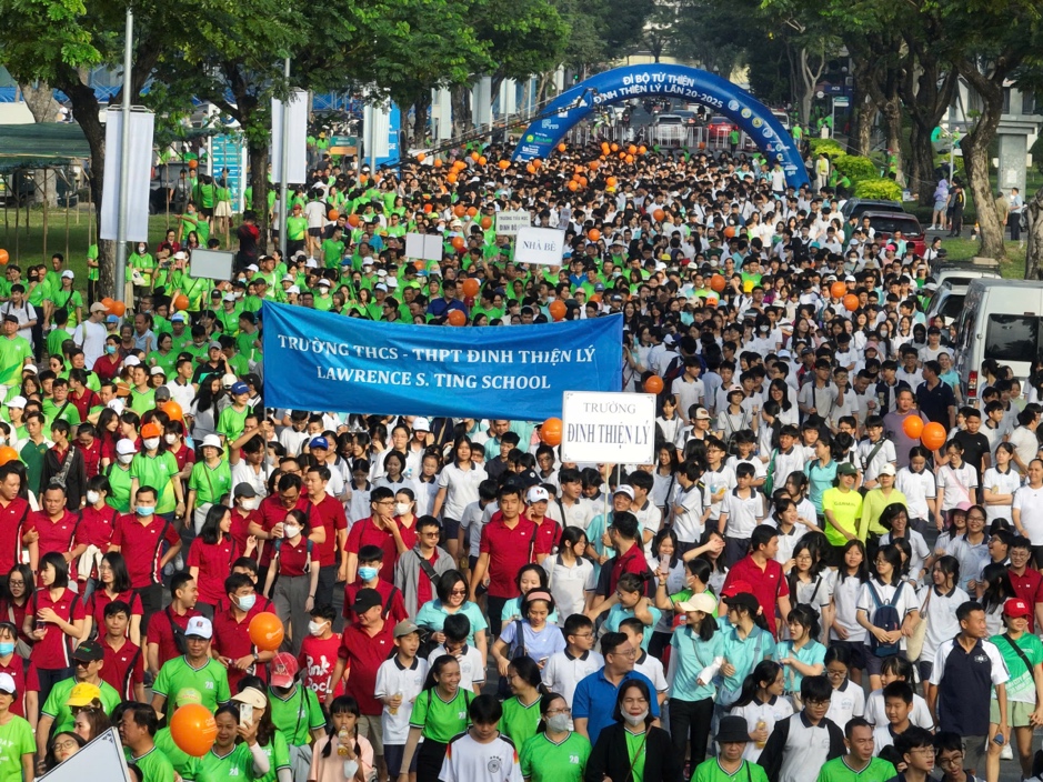 A large group of people walking in a street Description automatically generated