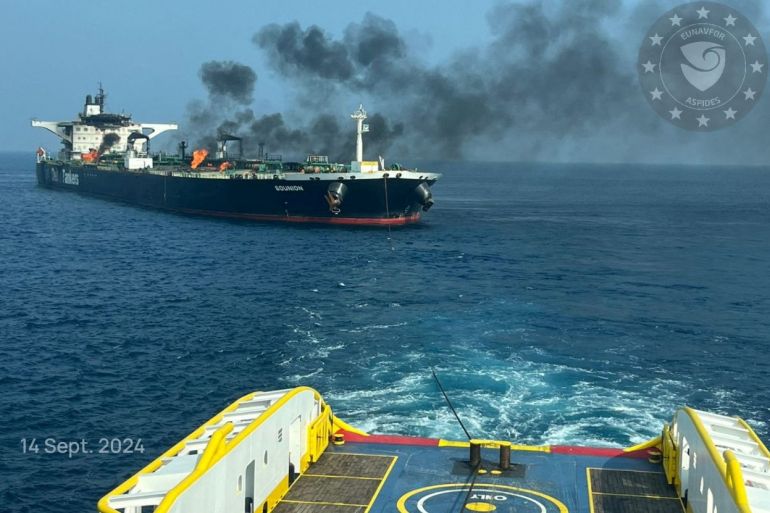 Flames and smoke rise from the damaged Greek-flagged oil tanker attacked by Houthis