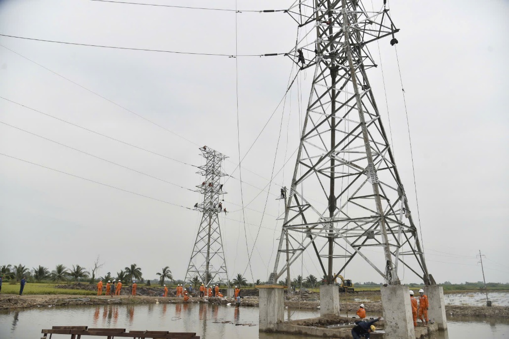 A group of people working on a power line Description automatically generated