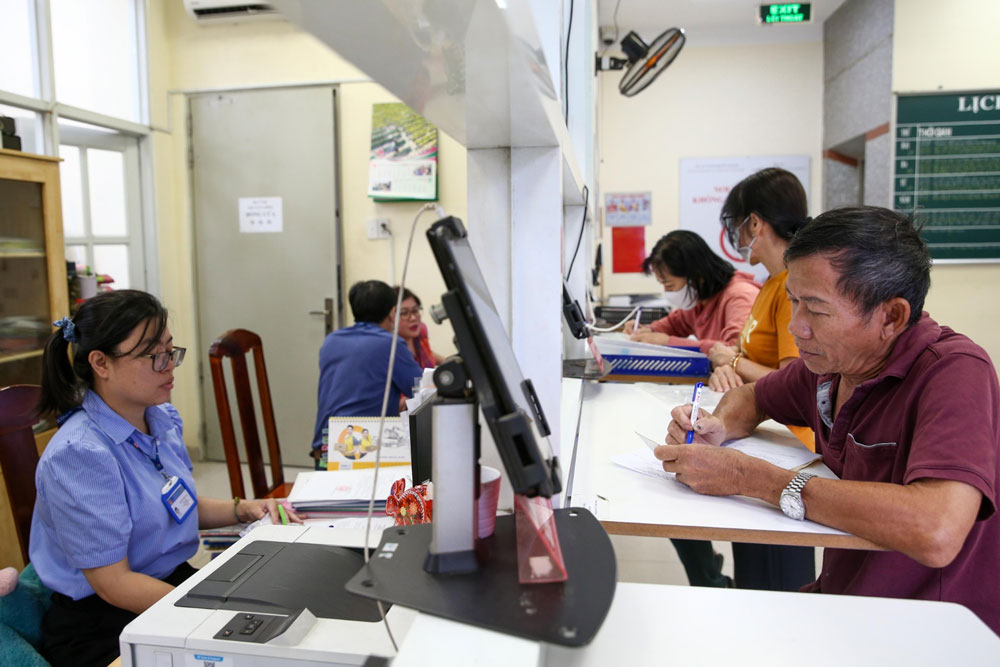 Cán bộ UBND phường 8, quận 10, TP HCM giải quyết thủ tục hành chính cho người dân. Ảnh: HOÀNG TRIỀU