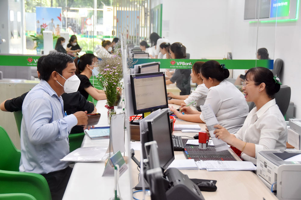 Phục vụ kh&aacute;ch h&agrave;ng tại một ng&acirc;n h&agrave;ng ở TP HCM. Ảnh: TẤN THẠNH