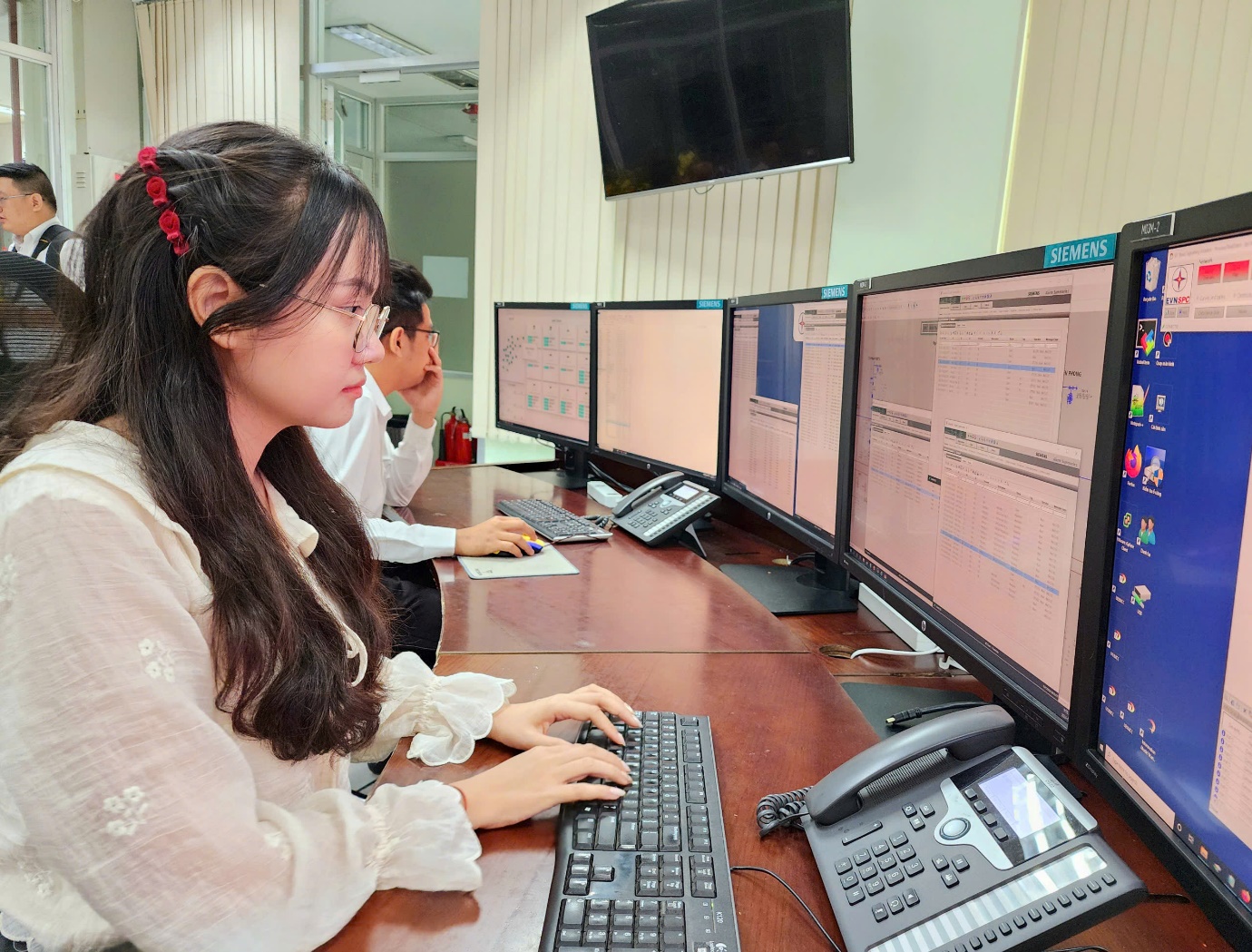 A group of people working on computers  AI-generated content may be incorrect.