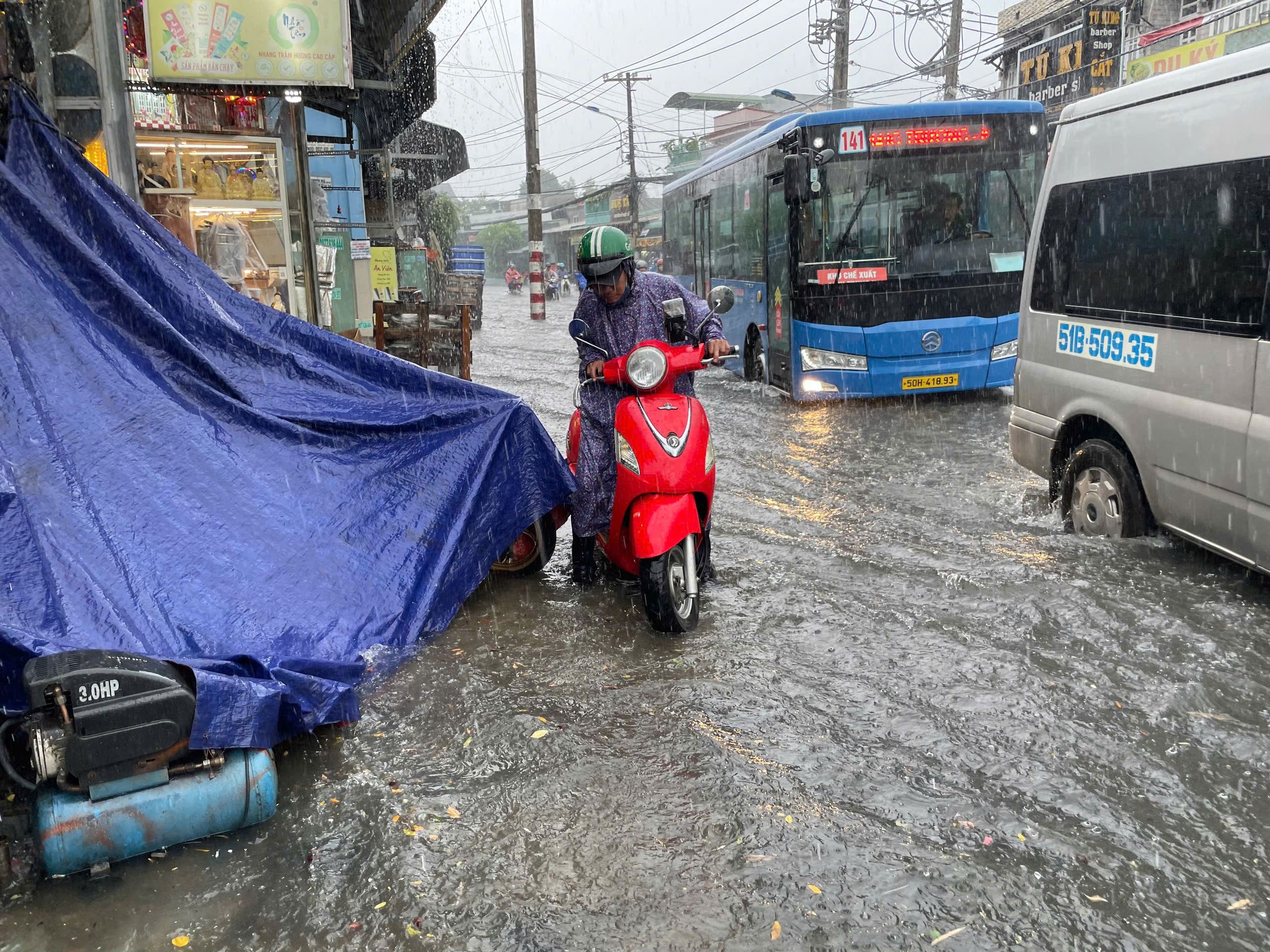 TP HCM mưa lớn kéo dài, người dân vất vả vì nhiều nơi ngập sâu- Ảnh 9.