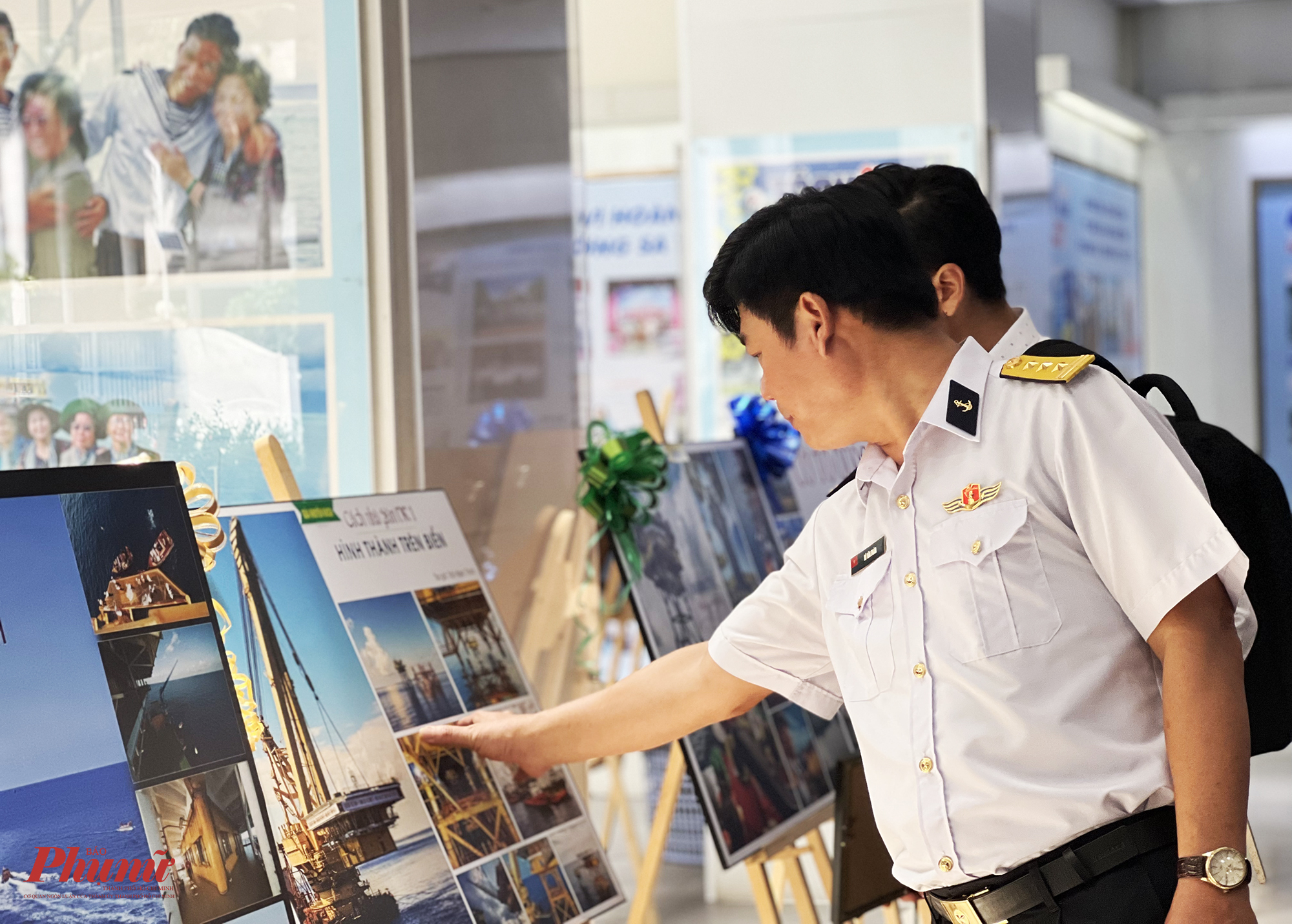 Kh&aacute;ch tham quan ngắm nh&igrave;n ch&ugrave;m ảnh C&aacute;ch nh&agrave; gi&agrave;n DKI h&igrave;nh th&agrave;nh tr&ecirc;n biển của t&aacute;c giả Trần Ngọc Thịnh đạt giải khuyến kh&iacute;ch. 