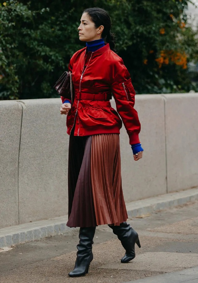 Tại London, gi&aacute;m đốc điều h&agrave;nh Caroline Issa cũng &ldquo;phải l&ograve;ng&rdquo; chất liệu satin khi chọn chiếc &aacute;o kho&aacute;c bomber m&agrave;u đỏ s&aacute;ng b&oacute;ng mix c&ugrave;ng thắt lưng đồng điệu, kết hợp th&ecirc;m &aacute;o cổ lọ m&agrave;u xanh dương v&agrave; ch&acirc;n v&aacute;y xếp ly bằng da c&oacute; 2 t&ocirc;ng m&agrave;u l&agrave;m bật l&ecirc;n phong c&aacute;ch ấn tượng.