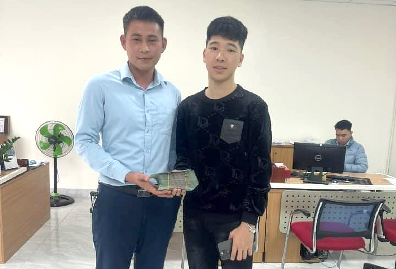 Ph&aacute;t (&aacute;o đen) ra ng&acirc;n h&agrave;ng r&uacute;t tiền chuyển trả lại cho người chuyển nhầm v&agrave;o t&agrave;i khoản của m&igrave;nh - Ảnh: Kh&aacute;nh Trung