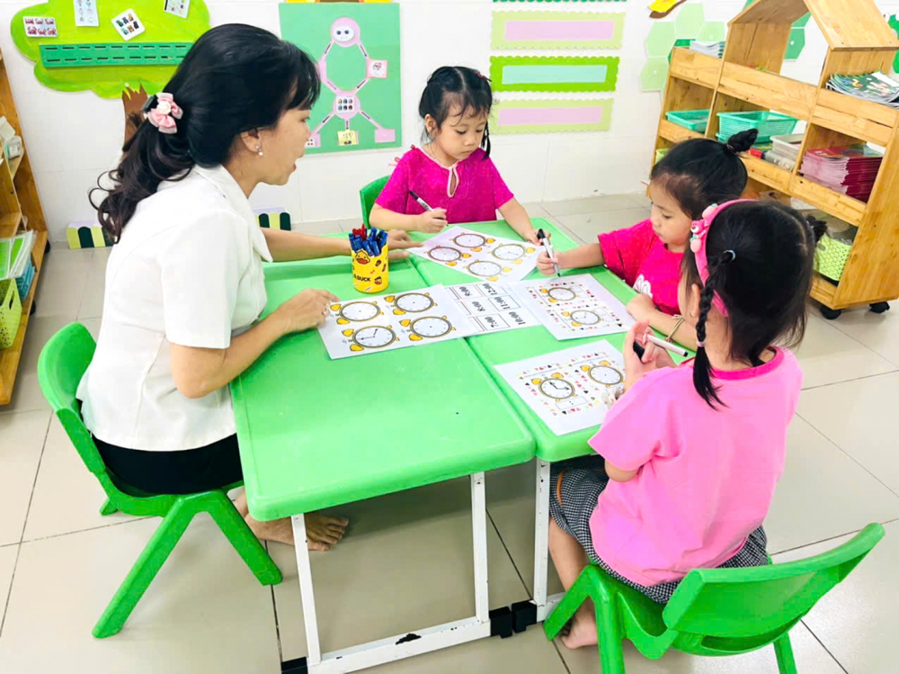 Học sinh lớp L&aacute; 2, Trường mầm non T&acirc;n Phong, quận 7, TPHCM học c&aacute;ch đọc giờ tr&ecirc;n đồng hồ kim