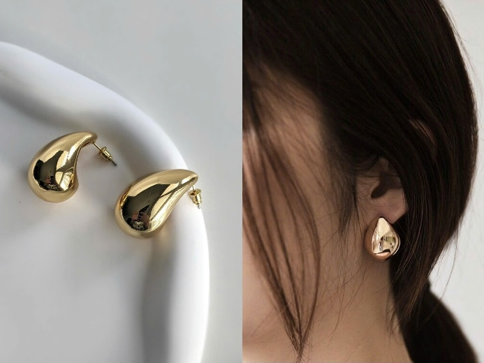 B&ocirc;ng tai &aacute;nh kim d&aacute;ng giọt nước với thiết kế bản lớn, c&ugrave;ng bề mặt &aacute;nh kim mang đến cho bạn cảm gi&aacute;c hiện đại v&agrave; vẫn giữ được sự mềm mại nhờ đường n&eacute;t bo tr&ograve;n nhẹ nh&agrave;ng. Kiểu b&ocirc;ng n&agrave;y ph&ugrave; hợp với những trang phục tối giản, gam trung t&iacute;nh v&agrave; đơn sắc, gi&uacute;p bạn tạo điểm nhấn m&agrave; kh&ocirc;ng l&agrave;m rối tổng thể. H&atilde;y thử phối c&ugrave;ng sơ mi cổ cao, v&aacute;y su&ocirc;ng v&agrave; &aacute;o hai d&acirc;y trơn đều c&oacute; thể mang lại sự nổi bật, ph&ugrave; hợp cả khi đi l&agrave;m lẫn dự tiệc nhỏ.