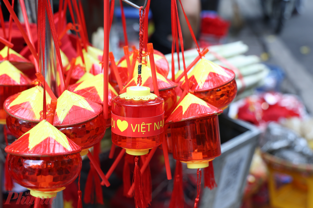Xen lẫn giữa phố l&agrave; những chiếc đ&egrave;n lồng mang đặc trưng Việt Nam với m&agrave;u đỏ, h&igrave;nh ảnh n&oacute;n l&aacute; c&ugrave;ng sao v&agrave;ng năm c&aacute;nh.