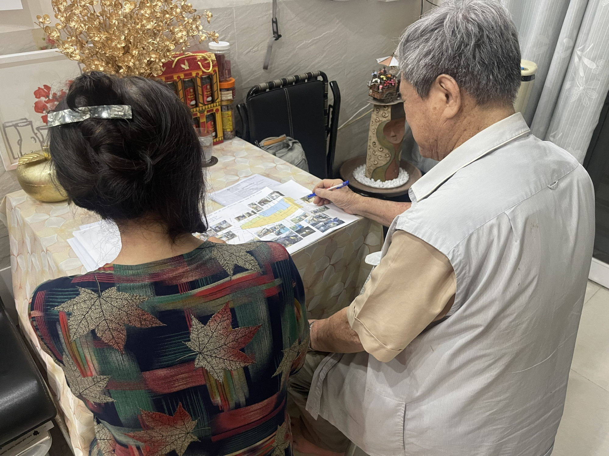 Vợ chồng &ocirc;ng T.V. b&ecirc;n đống đơn từ, hồ sơ chồng chất - Ảnh: DIệu Hiền
