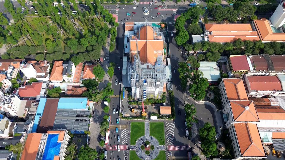 Two golden crosses ascend Saigon Notre Dame Cathedral's bell towers
