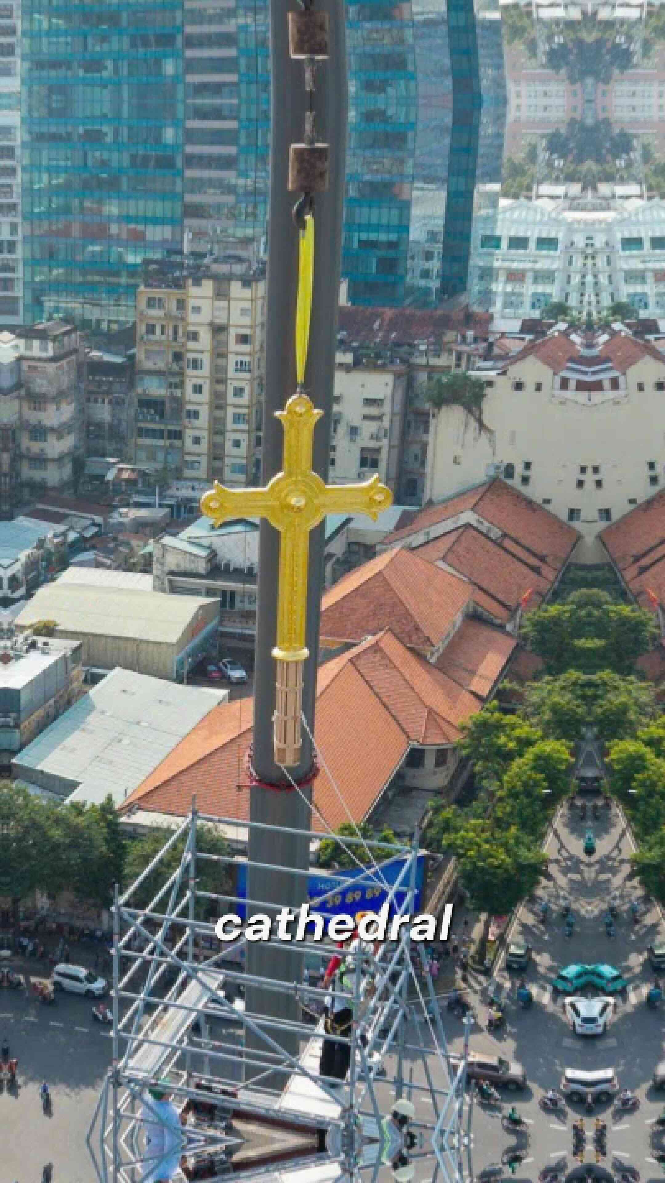 Two golden crosses ascend Saigon Notre Dame Cathedral’s bell towers