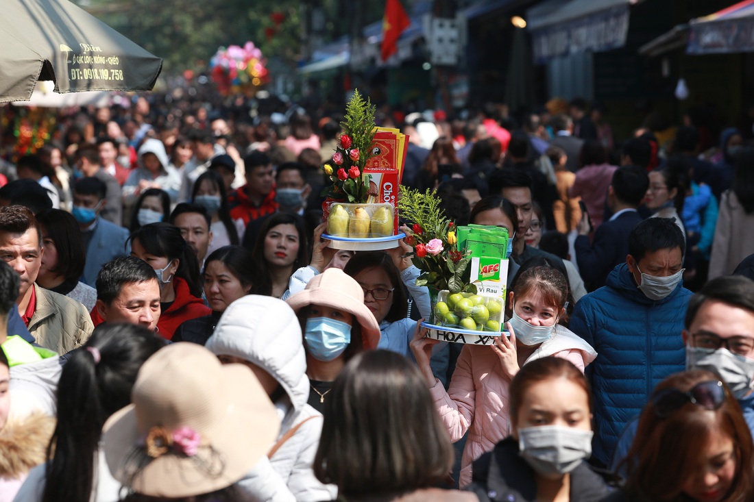 Giữa trưa, dân công sở ùn ùn đi lễ phủ Tây Hồ trong ngày làm đầu tiên sau tết - Ảnh 1.