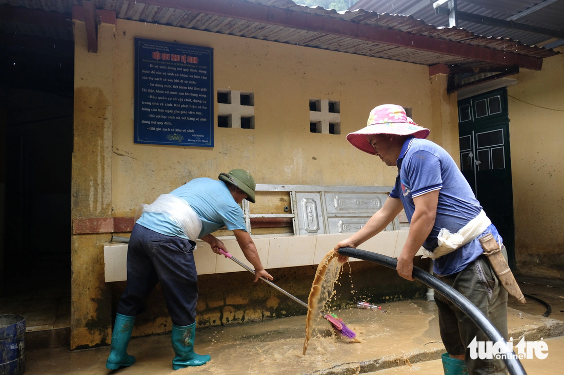 Các thầy cô xắn tay áo, tham gia làm mọi công việc để đón học sinh tới trường - Ảnh: NGUYÊN BẢO