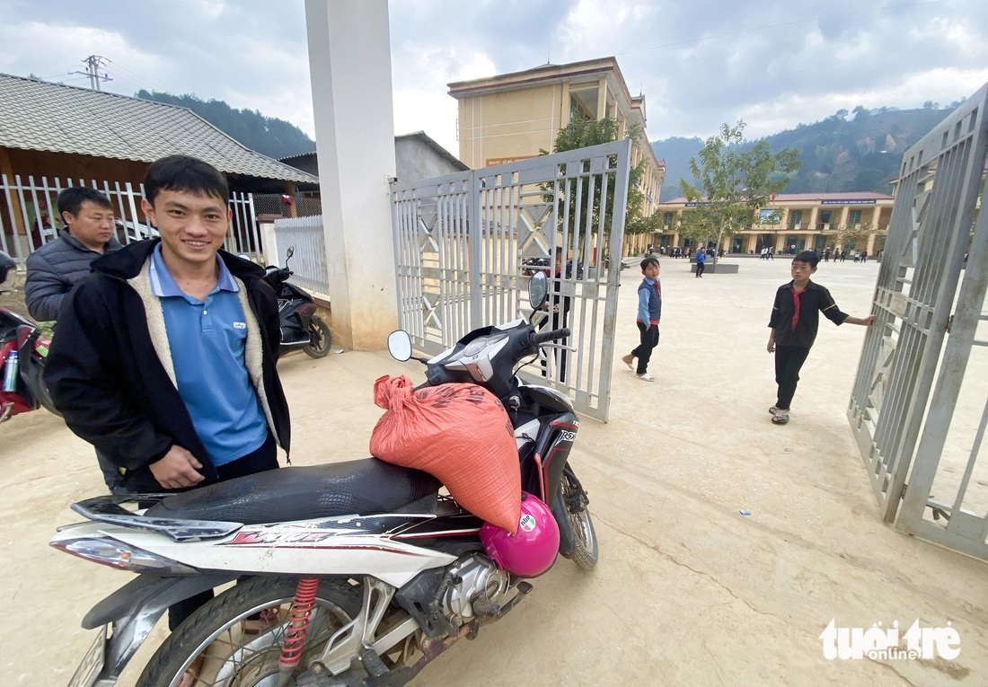 Anh Thào A Khày đi lấy gạo từ nhà phụ huynh học sinh về để nấu cho học sinh bán trú - Ảnh: C.TUỆ