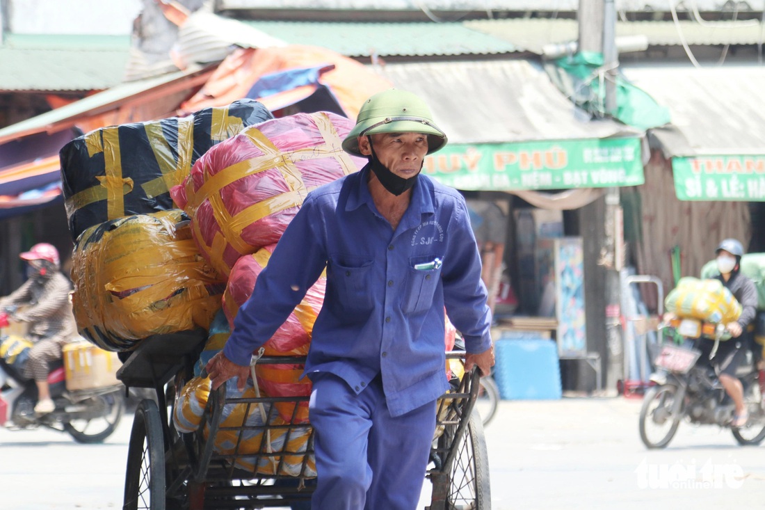 Ông Ngọc, làm nghề bốc vác thuê ở chợ Vinh, vất vả mưu sinh giữa nắng nóng - Ảnh: DOÃN HÒA