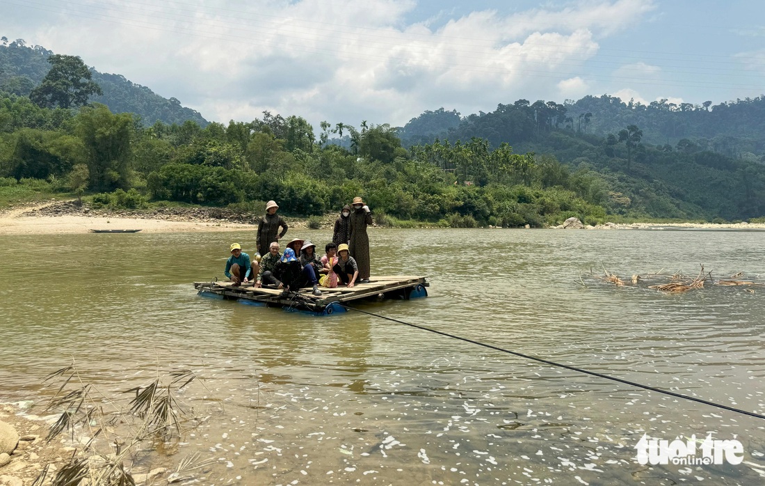 Một tốp 10 người vượt sông Tranh bằng bè - Ảnh: LÊ TRUNG