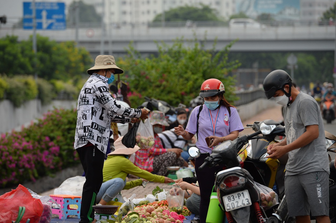 Công nhân làm việc tại Khu công nghiệp Vĩnh Lộc (TP.HCM) đi chợ lề đường sau giờ tan ca - Ảnh: TỰ TRUNG