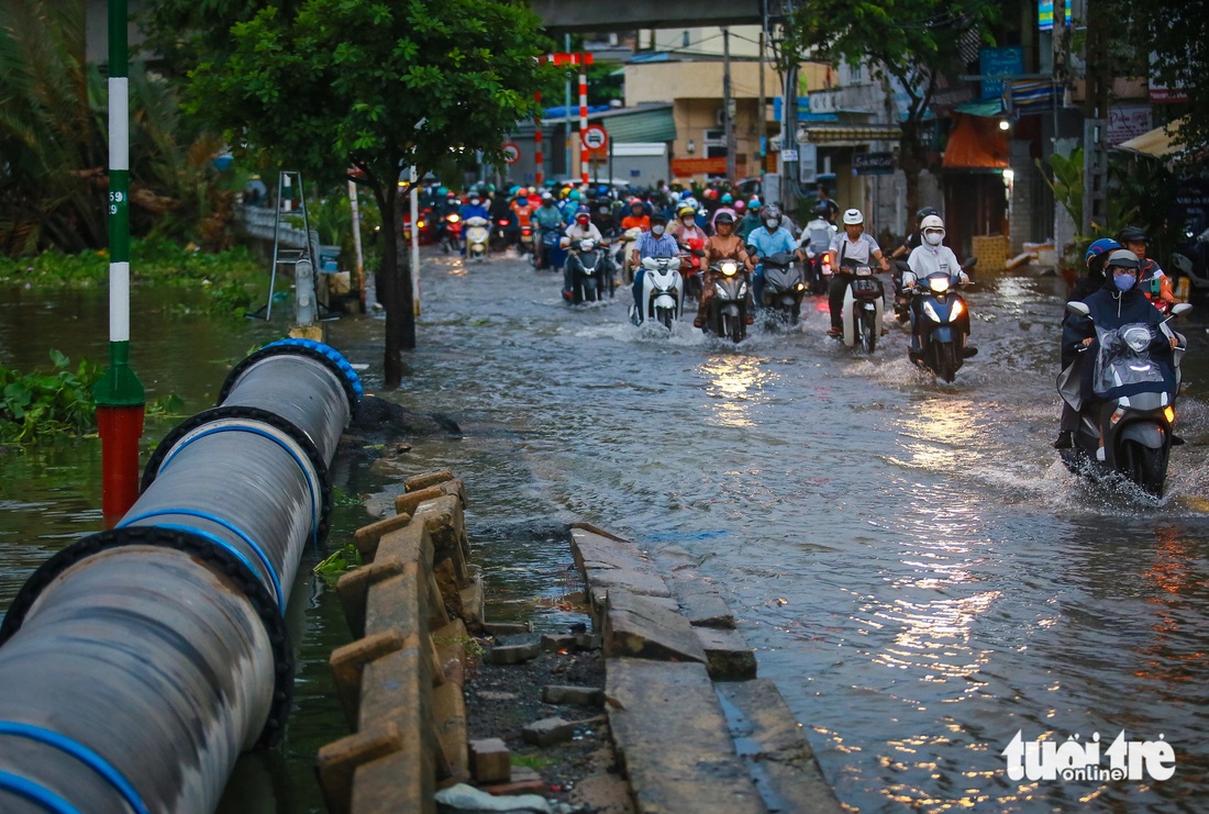 TP.HCM đón đợt triều cường đầu mùa, xe máy dắt bộ, xe hơi quay đầu - Ảnh 2.