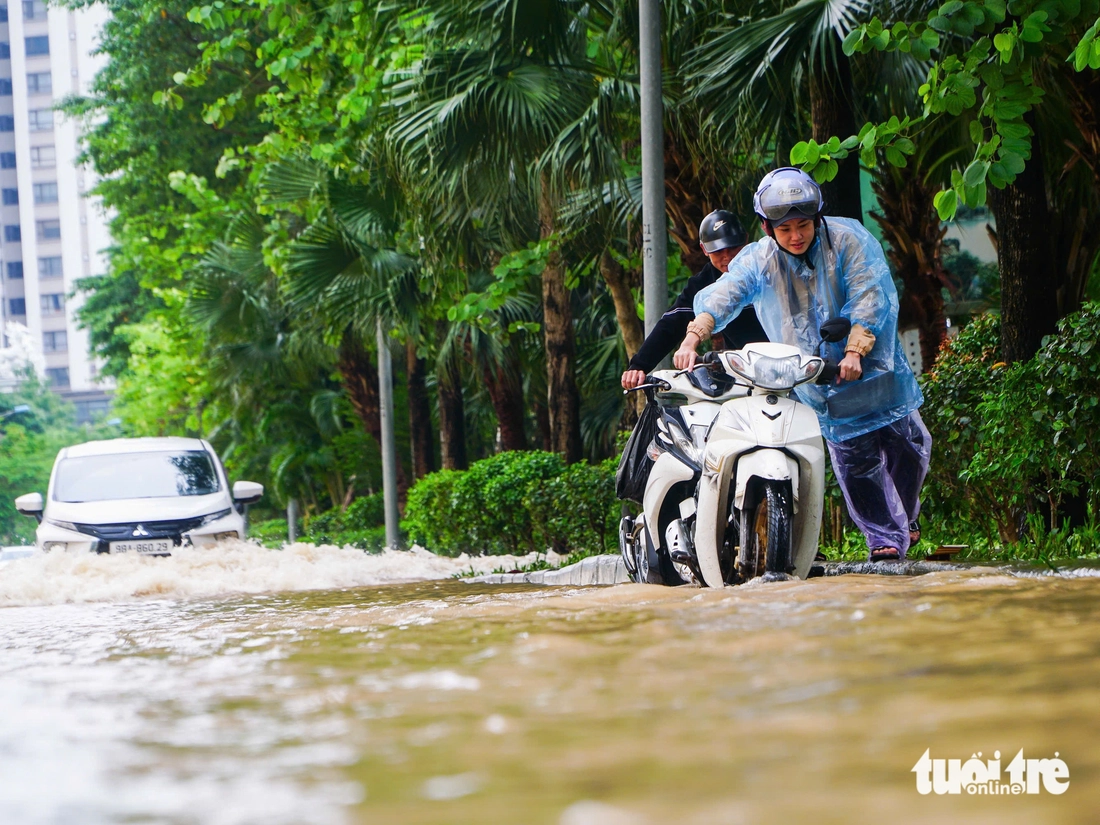 Hà Nội vẫn ngập khắp nơi, thợ sửa xe 'cắm chốt' ngay tại điểm ngập để sửa xe chết máy - Ảnh 9.