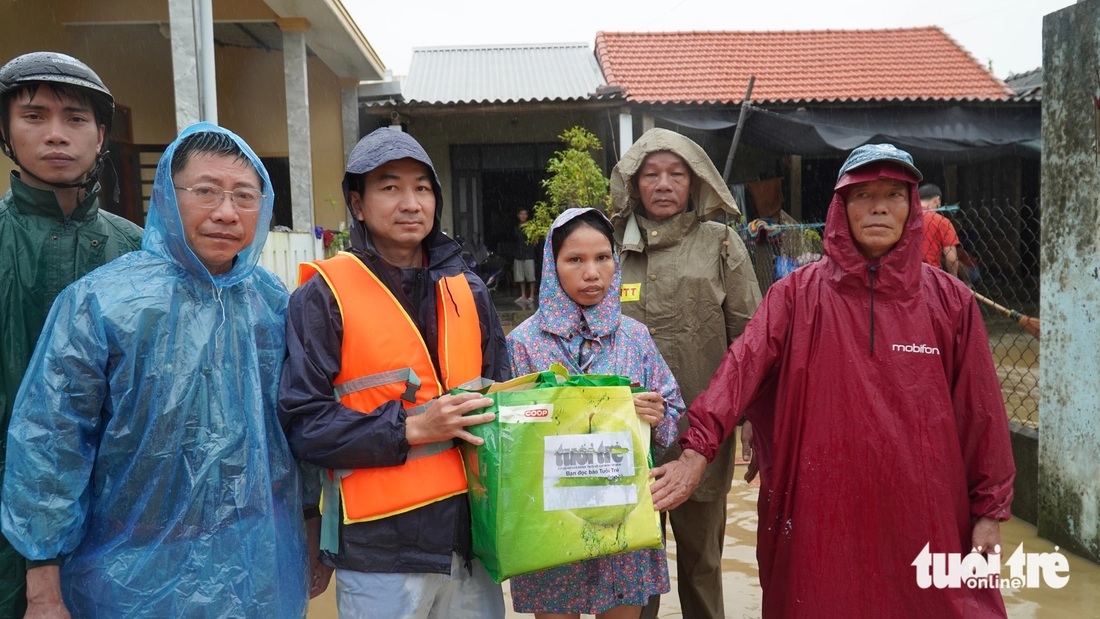 Hàng trăm suất quà cứu trợ của báo Tuổi Trẻ băng nước lũ đến với bà con vùng ngập sâu - Ảnh 5.