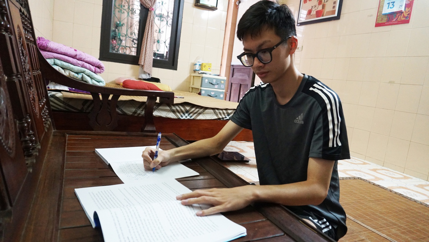 Chiếc ghế đặt ở phòng khách cũng chính là "bàn học" quen thuộc của Minh - Ảnh: TIẾN THẮNG