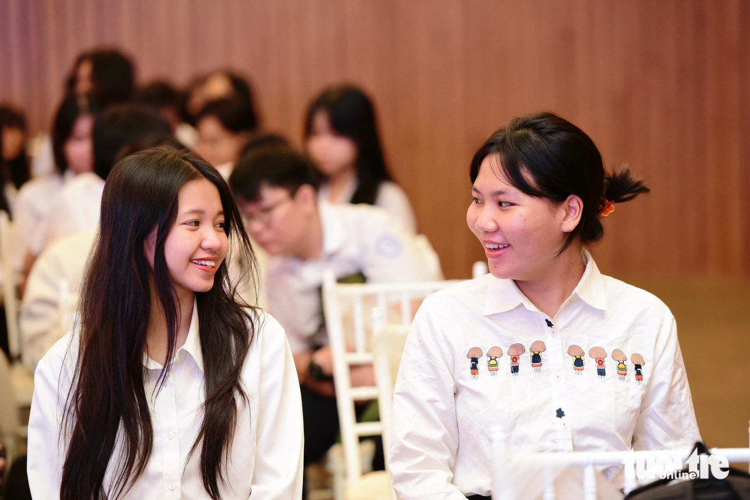 Gia Hân (bên phải) trò chuyện cùng bạn trước giờ lên nhận học bổng Tiếp sức đến trường - Ảnh: DUYÊN PHAN
