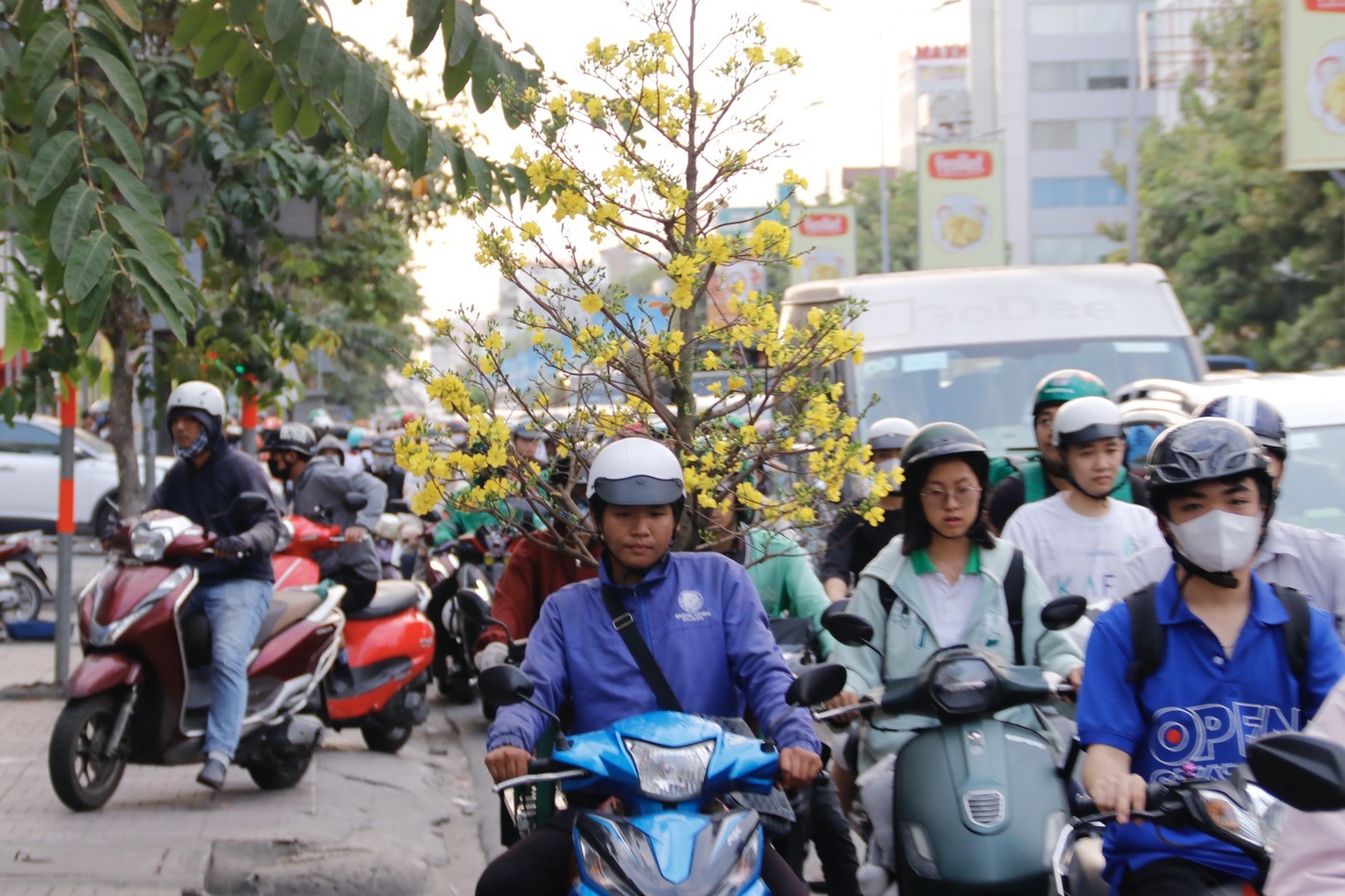 Người giao hoa Tết trót đi vào quãng kẹt trên đường Cộng Hòa nơm nớp lo hoa của khách bị hư hỏng do va quẹt - Ảnh: TIẾN QUỐC