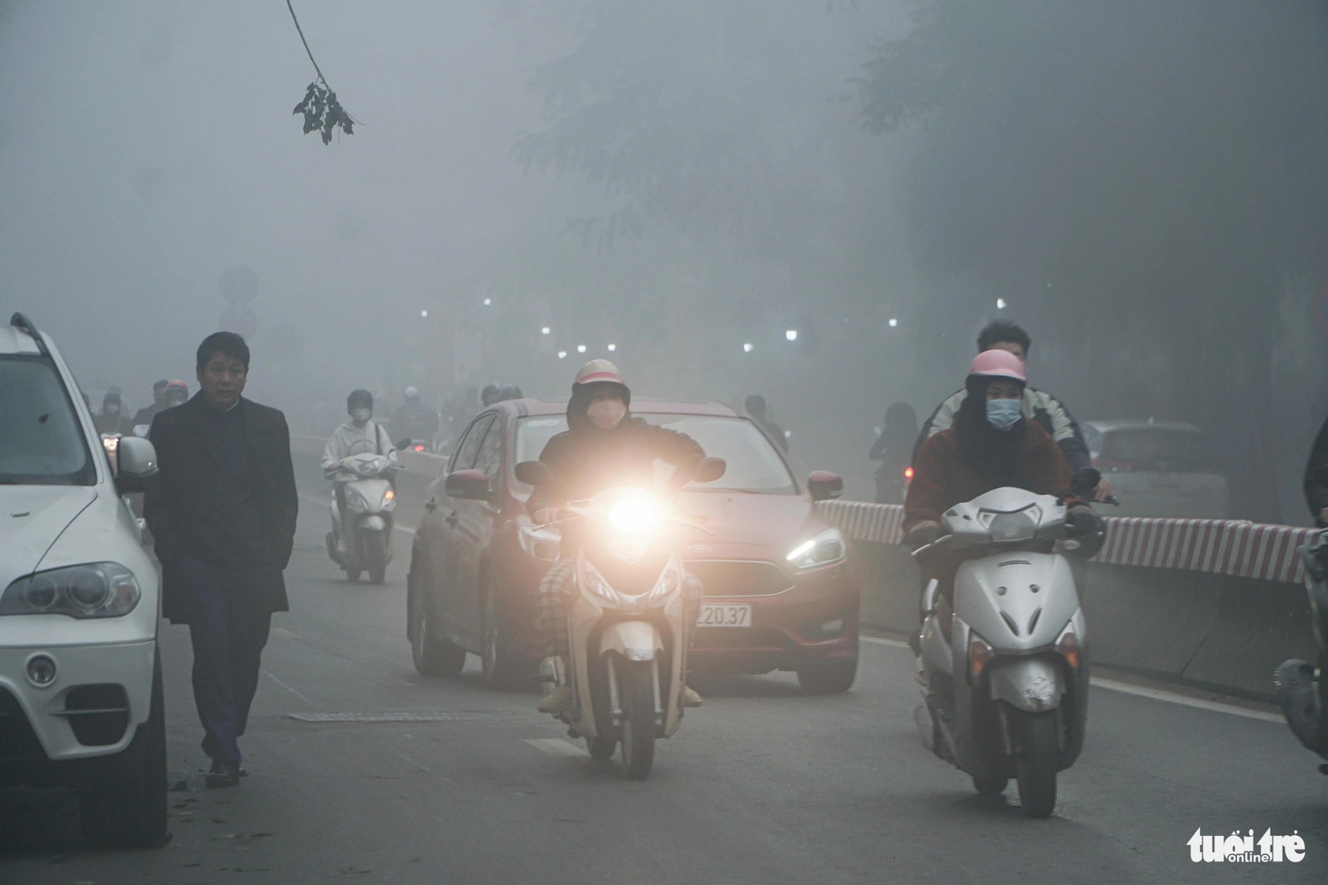 Người dân bật đèn xe giữa ban ngày - Ảnh: PHẠM TUẤN