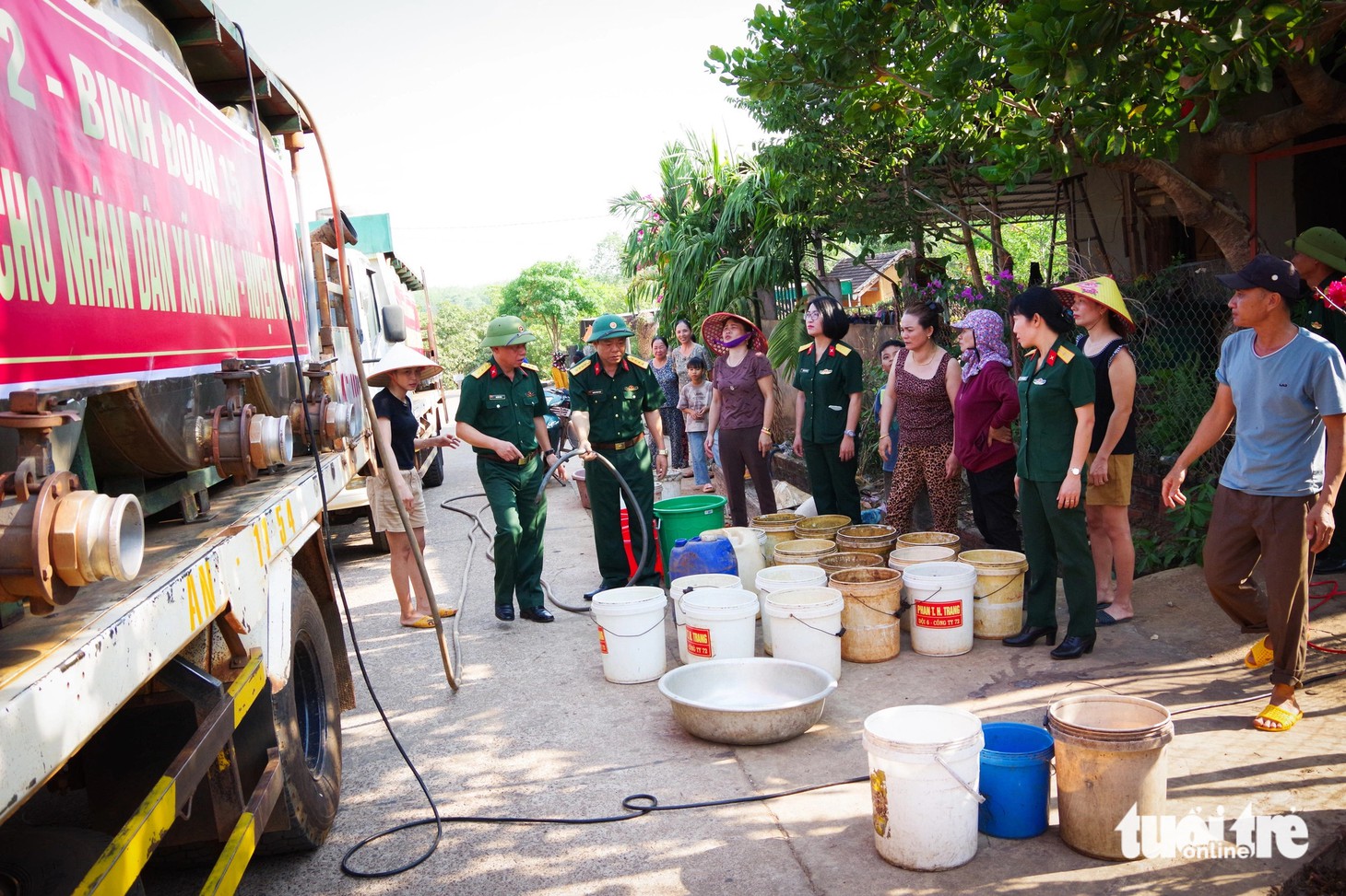 Buổi sáng hằng ngày, người dân xã Ia Nan mang xô chậu ra đường chờ xe bộ đội tiếp tế nước - Ảnh: VĂN ĐÀN