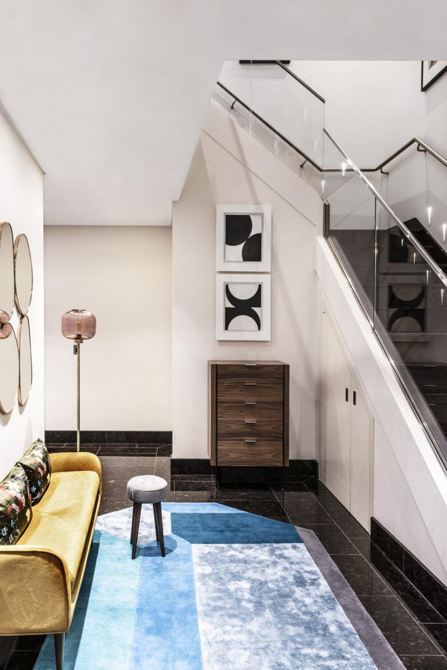 Khu vực đón khách thân thiện với ghế sofa nhỏ màu vàng và tấm thảm màu xanh - Ảnh: HGTV