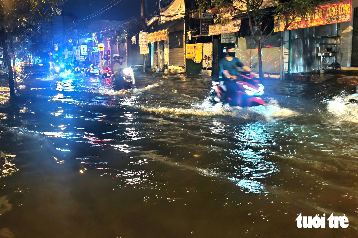 Đường Mã Lò ở TP.HCM ngập sau cơn mưa 30 phút, người dân bì bõm về nhà trong đêm - Ảnh 1.
