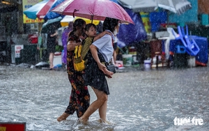 Heavy rains flood Hanoi streets again, residents struggle to get home - Ảnh 10.