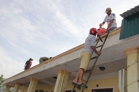 Thầy giáo leo mái nhà lợp ngói trường học sau bão - Ảnh 3. Thầy giáo leo mái nhà lợp ngói trường học sau bão - Ảnh 3.