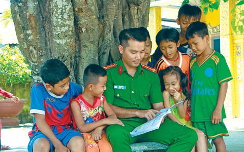 Trưởng công an xã dạy học không công, cắt tóc miễn phí cho trẻ em - Ảnh 1. Trưởng công an xã dạy học không công, cắt tóc miễn phí cho trẻ em - Ảnh 1.