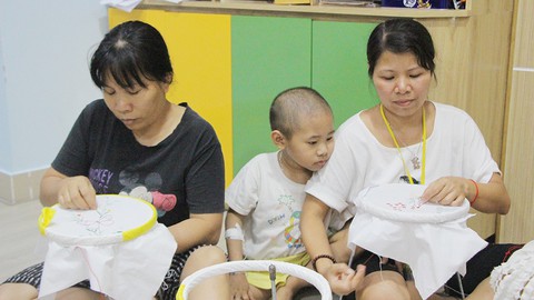 Vừa học thêu vừa chăm con bệnh - Ảnh 1. Vừa học thêu vừa chăm con bệnh - Ảnh 1.