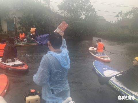 Chèo sup tiếp hàng cứu trợ bà con cô lập trong lũ - Ảnh 5. Chèo sup tiếp hàng cứu trợ bà con cô lập trong lũ - Ảnh 5.