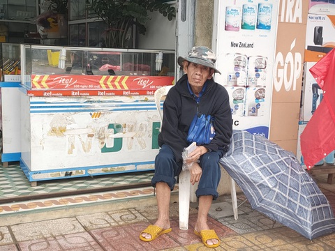 Những người già bán vé số đội mưa, co ro trong giá rét để mưu sinh - Ảnh 5. Những người già bán vé số đội mưa, co ro trong giá rét để mưu sinh - Ảnh 5.