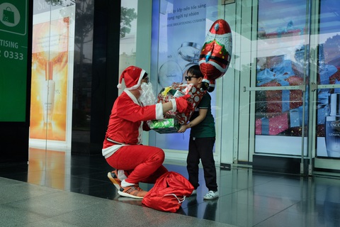 Ông già Noel đeo khẩu trang, tất bật chạy show tặng quà Giáng sinh - Ảnh 3. Ông già Noel đeo khẩu trang, tất bật chạy show tặng quà Giáng sinh - Ảnh 3.