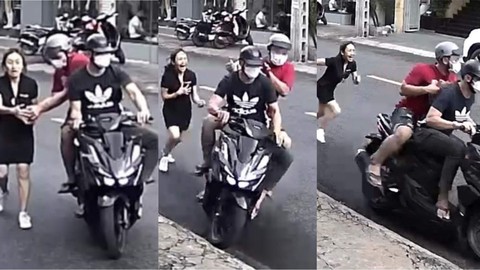 Cô gái bị giật điện thoại, ví tiền khi đi bộ dưới lòng đường - Ảnh 1. Cô gái bị giật điện thoại, ví tiền khi đi bộ dưới lòng đường - Ảnh 1.