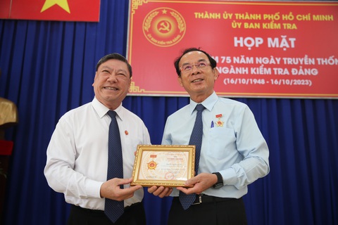 Bí thư Nguyễn Văn Nên: Ngành kiểm tra Đảng TP.HCM góp phần xử lý nghiêm minh tham nhũng, tiêu cực - Ảnh 3. Phó chủ nhiệm thường trực Ủy ban Kiểm tra Trung ương Trần Văn Rón trao kỷ niệm chương “Vì sự nghiệp kiểm tra của Đảng” cho Bí thư Nguyễn Văn Nên - Ảnh: TIẾN LONG