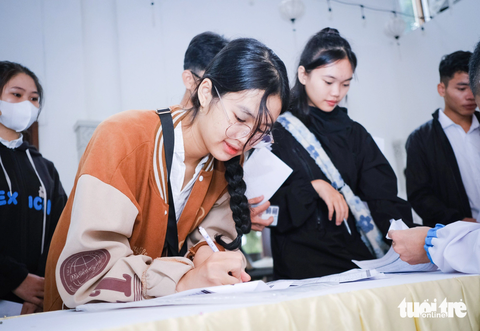 Các tân sinh viên Quảng Nam - Đà Nẵng vui mừng khoe hồ sơ mở tài khoản nhận học bổng - Ảnh: TẤN LỰC Tại sảnh trước sân khấu của chương trình, các tình nguyện viên thuộc tỉnh đoàn Quảng Nam đã hướng dẫn tân sinh viên hoàn thành thủ tục mở tài khoản học bổng Tiếp sức đến trường. Trong ảnh: tân sinh viên Trường Đại học Duy Tân - Hoàng Thị Khánh My làm thủ tục mở tài khoản nhận học bổng Tiếp sức đến trường - Ảnh: TẤN LỰC