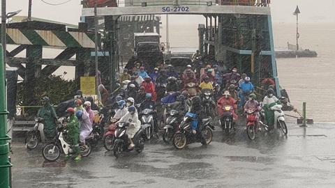 Người dân đội mưa đi làm ở bến phà Cát Lái, TP. Thủ Đức- Ảnh: TỰ TRUNG Người dân đội mưa đi làm ở bến phà Cát Lái, TP Thủ Đức- Ảnh: TỰ TRUNG