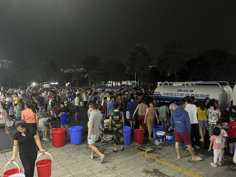 Cư dân khu đô thị Thanh Hà vẫn xếp hàng hứng từng giọt nước - Ảnh 1. Tối 22-10, cư dân khu đô thị Thanh Hà vẫn xếp hàng để xách nước từ xe téc về nhà sử dụng - Ảnh: H.Q.