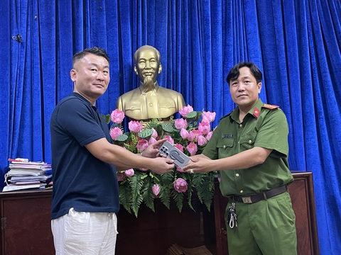 Nhanh chóng tóm gọn tên cướp giật, trả lại tài sản cho người nước ngoài - Ảnh 1. Công an phường 13, quận 4 trao trả lại chiếc điện thoại bị cướp cho anh Sim Jun Young - Ảnh: Công an cung cấp