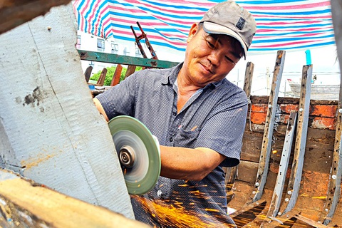 "Bắt bệnh bốc thuốc" cho tàu ra khơi - Ảnh 2. Ông Nguyễn Văn Ngọc hơn 30 năm gắn bó với nghề cho biết nghề này phải đóng chính xác từng cây đinh, con ốc, đường cắt trên tàu...