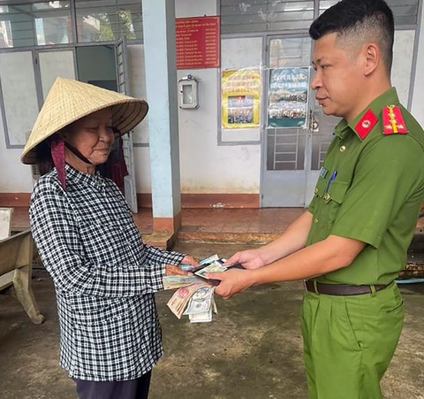 Người bán vé số trả lại ví tiền chứa gần 20 triệu đồng cho người đánh rơi - Ảnh 1. Bà Đinh Thị Hoa, người bán vé số nhặt được ví tiền chứa gần 20 triệu đồng, bàn giao cho lực lượng công an tìm kiếm người đánh rơi để trả lại - Ảnh: MINH ĐĂNG